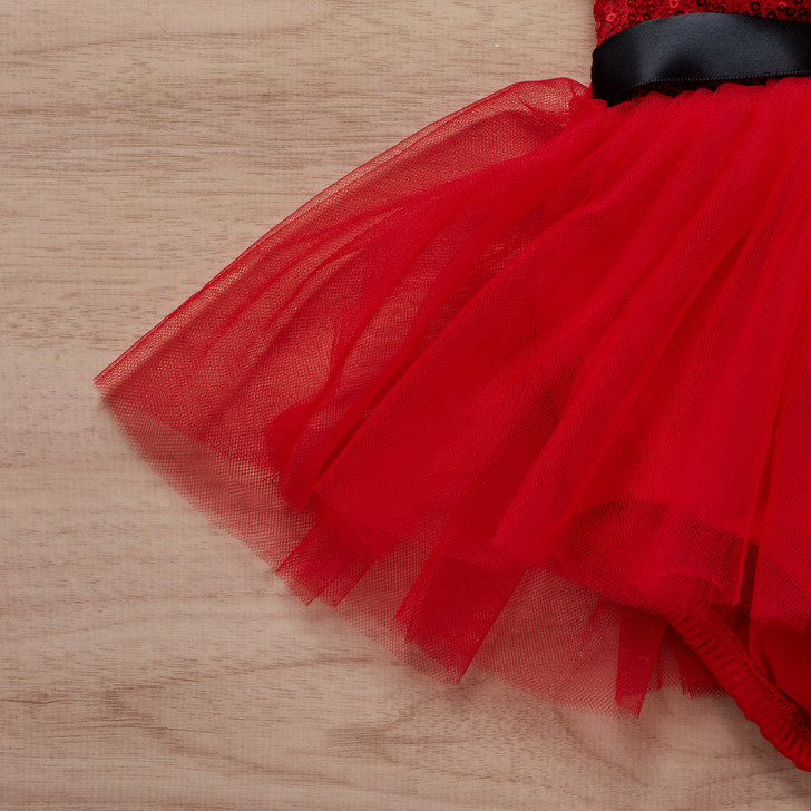 Generic Christmas Romper Sequins Short Romper Skirt, red tulle skirt with a black waistband on a wooden surface.