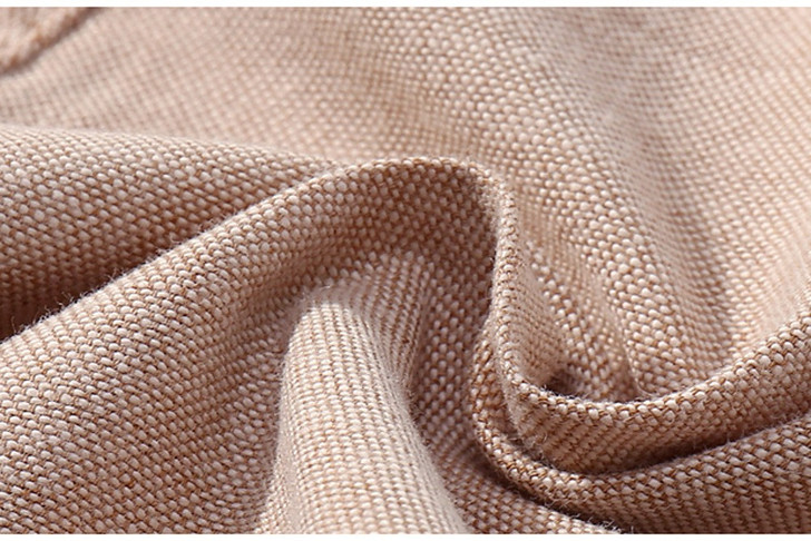 OONA Short-Sleeve Romper Short Suit with Hat, close-up view of beige woven fabric material.