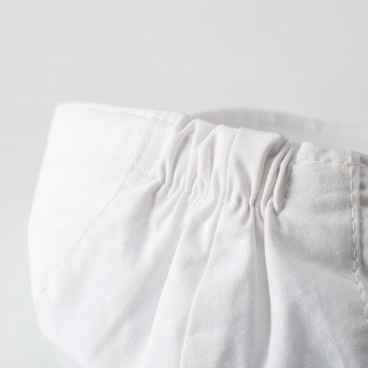 OONA White Romper Suit Boy Set Vest with Hat, close-up of the white romper's elastic waistband and fabric details.
