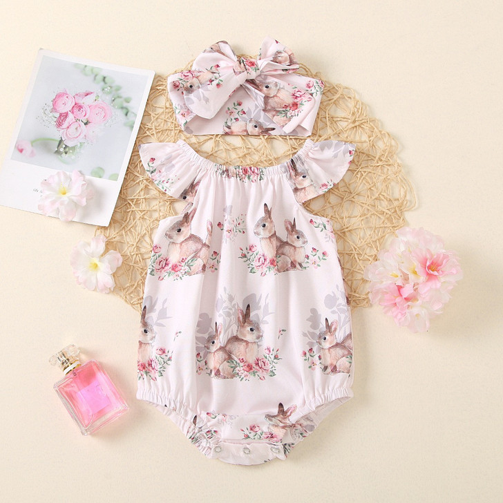 OONA Easter OutfitBunny Jumpsuit My First Easter, a pink and white baby romper with bunny and floral print, matching headband, and decorative pink flowers.