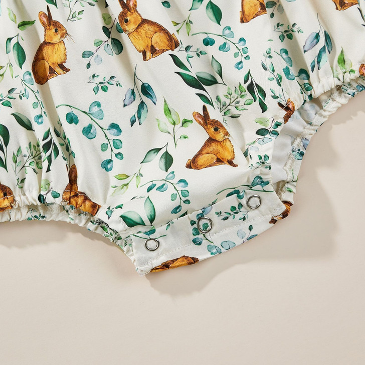 OONA Easter Romper Bodysuit Bunny Headbands Set, close-up of a white baby romper with a bunny and foliage print, featuring snap closures.