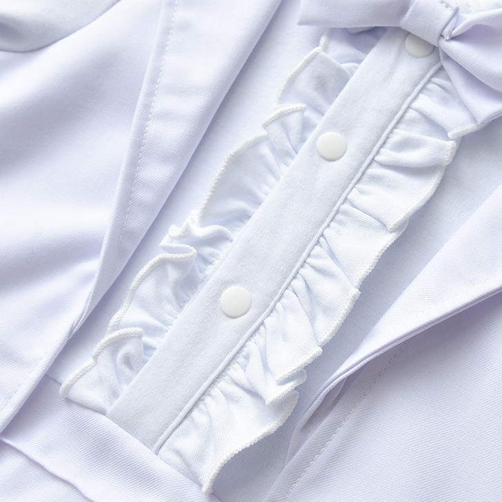 White Tuxedo Boy Cotton Romper, close-up of the detailed front with ruffles, buttons, and bow tie.