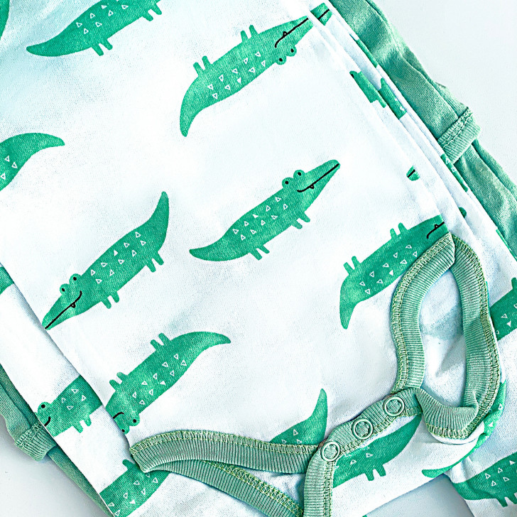 Generic Alligator Layette Set 8 Piece, baby clothing with green alligator print on white fabric.