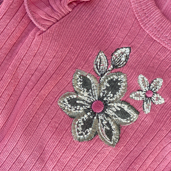 Generic Flower Layette Set 4 Piece, detailed embroidery of pink flowers with black and white accents on soft pink fabric.