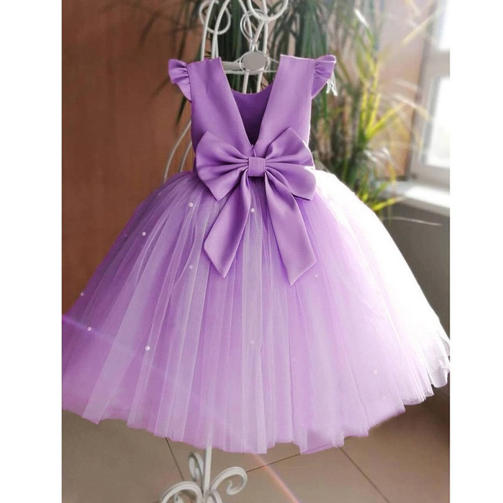 OONA Amelia Tulle Klosh, purple girl dress with sleeveless design, large bow at waist, and layered tulle skirt with small pearl embellishments.