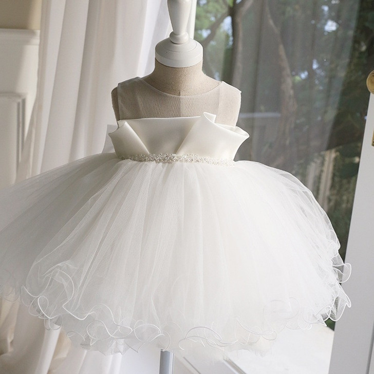 OONA Emma Tulle Bouffant, a beautiful white children's dress with a full tulle skirt and satin bodice with pearl embellishments.