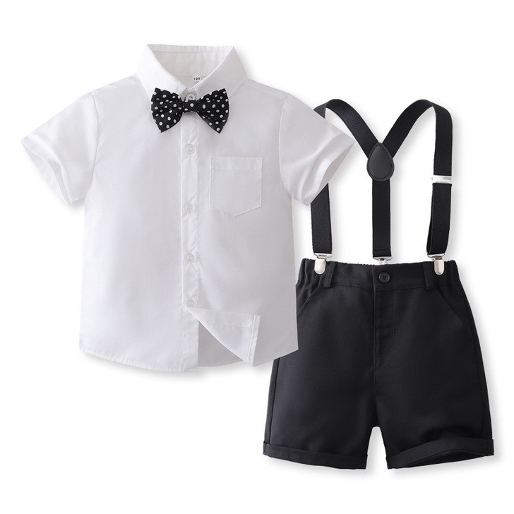 OONA Mike Short Suite Suspender, a children's formal outfit featuring a white short-sleeve shirt with a black polka dot bow tie, black shorts with suspenders.