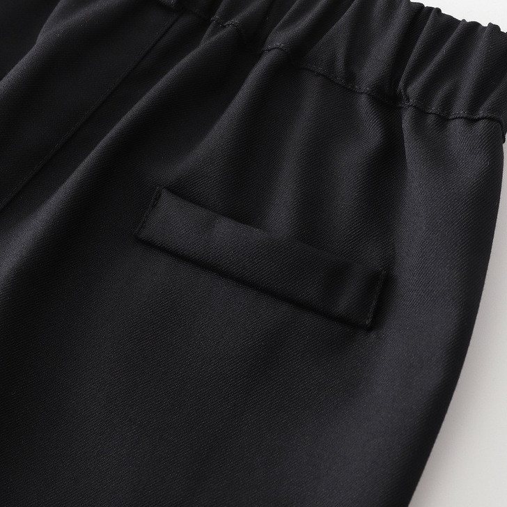 OONA Mike Short Suite Suspender, close-up of black fabric with an elastic waistband and a welt pocket.
