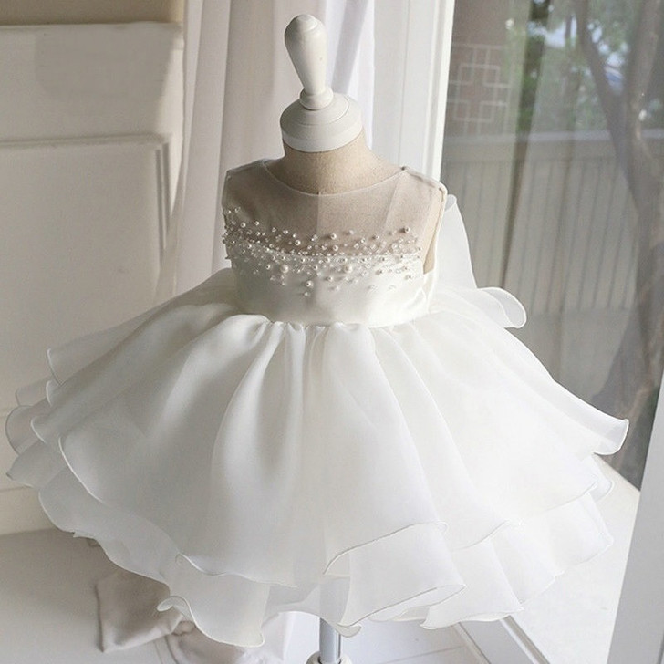 OONA Lea White Bouffant Dress, white formal dress for special occasions with pearl embellishments on the bodice and a layered, ruffled skirt.