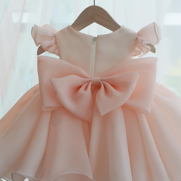 OONA Hazel Bouffant Dress, light pink elegant girl's dress with large bow and ruffled sleeves.