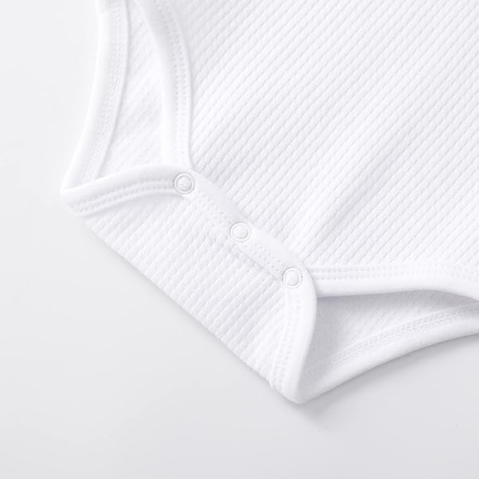 Minnie Me Cotton Romper Neutral, close-up image of the white textured cotton romper with snap buttons at the bottom for easy dressing.