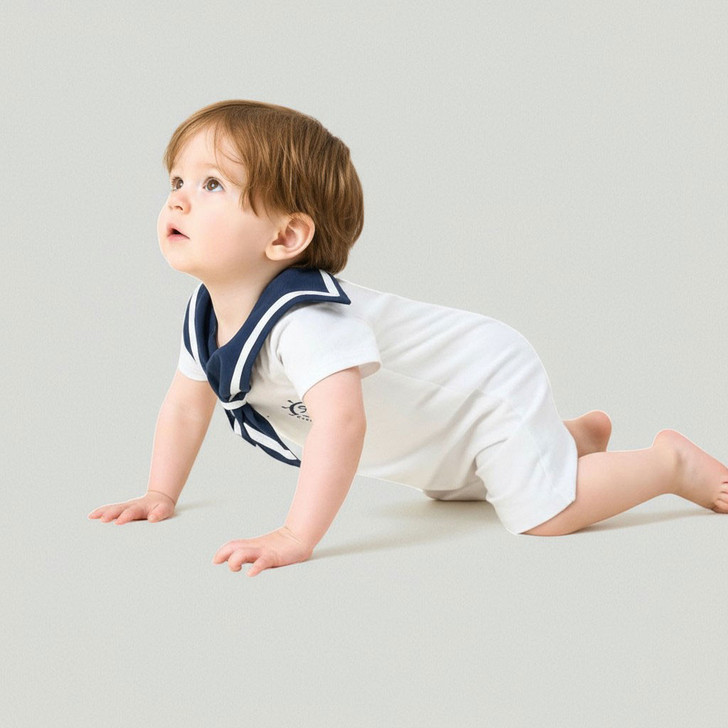 Minnie Me Blue Collar Romper, baby crawling in a white romper with navy blue sailor collar