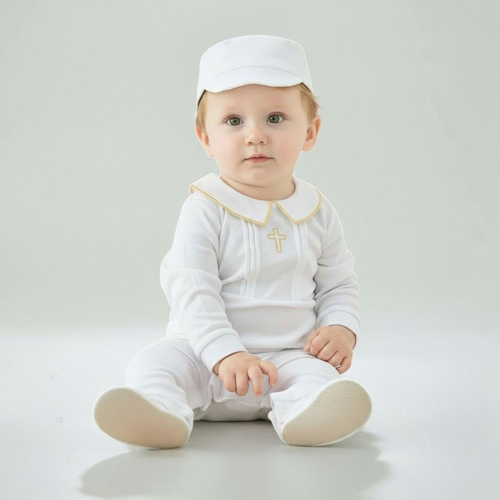 Minnie Me White Romper Christening Essential, image of a cute baby girl wearing a white christening romper with gold accents, a matching white hat, and sitting on a clean white surface.