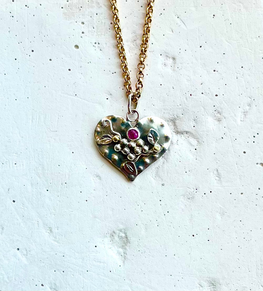 Sterling and fine silver heart necklace with, silver and 18k yellow gold balls, pinkish-red ruby, message on the back "Heart's Desire". 14k GF 18" chain. Designed and hand fabricated by, J A Lindberg. One of a kind.