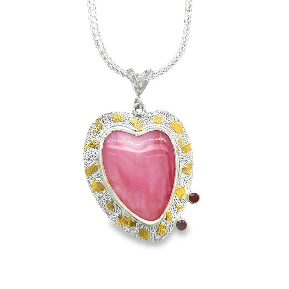 Peruvian Pink Opal Heart with 22K gold accents and Rubies. I carved this offset pink opal and added 2 small rubies. Mixed with 22K gold accents on a hand textured sterling silver backing. 18” silver foxtail chain included.