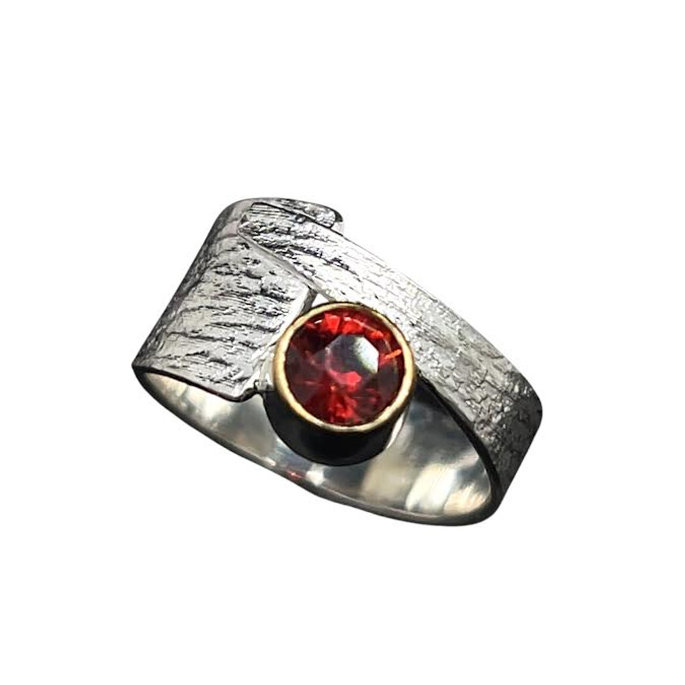 Offset Garnet Ring with 22K gold rim. I cut this Burnt red orange Malaya Garnet in a ‘Classic’ cut design. Very bright stone rimmed with 22K gold setting and set in an offset textured sterling silver ring shank sized 7.