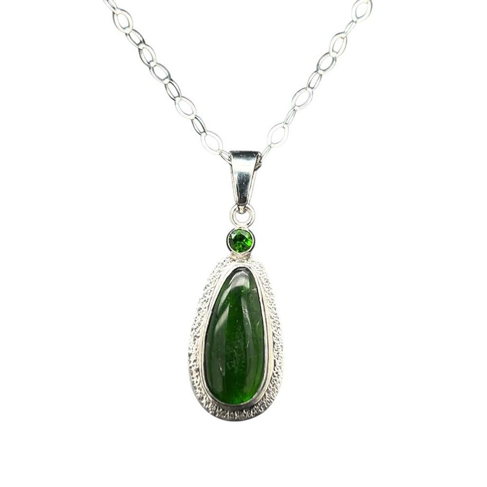 Chrome Diopside Pendant. I cut this saturated deep green crystal which originated from Siberia into a teardrop shape. It is accompanied by a faceted chrome diopside stone. It almost looks like an emerald. Set in fine silver with hand textured rim and sterling silver 18” chain included.