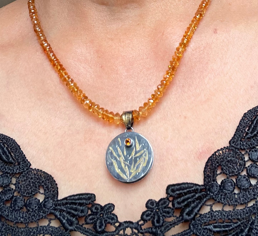 Faceted Madeira citrine beads with a silver /gold pendant