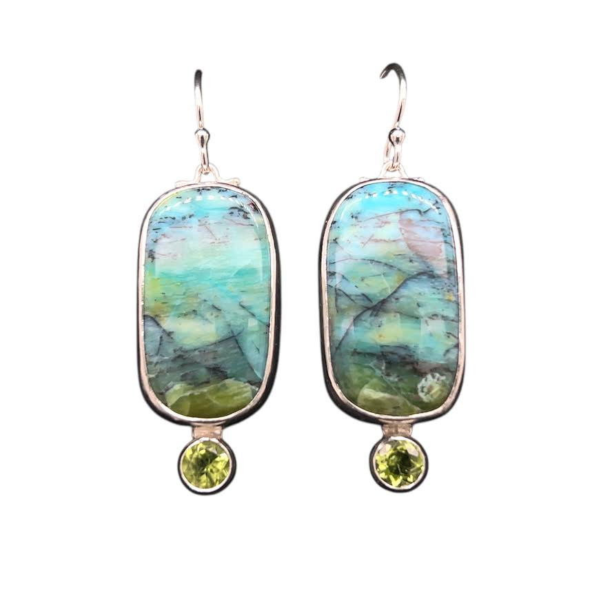 Opalized Petrified Wood Earrings 2. This really cool material comes from Indonesia and I cut these unique shapes with a bookend cut technique so the earrings are mirror images of each other. Peridot accents with fine silver bezel and sterling silver ear wire components. 1.5” L by 1”W.
