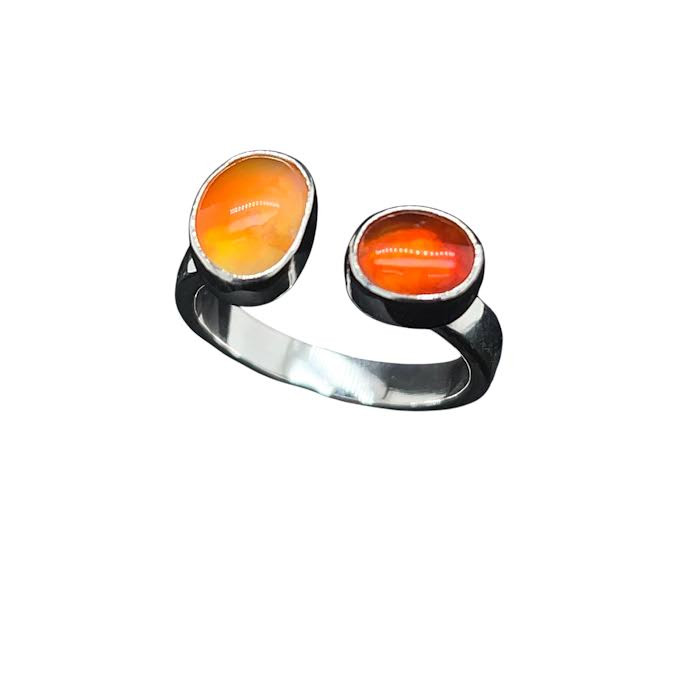 Fire Opal Omega Ring. I made this open shank ring with 2 fire opals that I cut from a nodule from Mexico. Set in sterling silver in a size 7 ring that is adjustable.