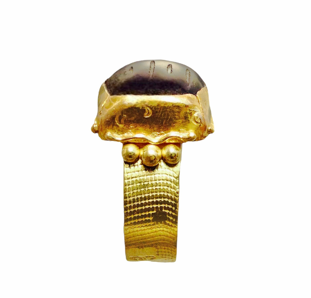 Ancient style ring, designed and handcrafted by the artist in 18k yellow gold with a rough scarab carved amethyst. One of a kind by, J A Lindberg