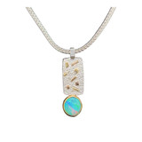 Opal Pendant with 22K gold and silver. Extremely bright opal I cut from Ethiopia with intense blue and green patterned flashes. Set in a 22K high gold bezel and 14K gold backplate. Small highlights are done in 18K gold on a silver textured sheet. Comes with 18”  silver chain.