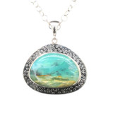 Peruvian Opal Pendant. I cut this unique shape from a gemmy specimen from Peru. The translucent material is harder to come by and the unique scenery reminds me of the ocean. Surrounded by ‘bubbles’ it is set in fine silver and sterling silver components. 18” silver chain included.