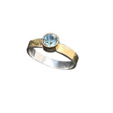Montana Sapphire Gold & Silver Ring. I cut this beautiful Blue Green Montana sapphire in a design called ‘Mini Mint’. The design has extra facets on the table to accentuate the brilliance of the stone. There are over 70 total facets in the design which are cut at least 4 times each! The sapphire is ¾ of a carat and set in 18K gold with a 14K textured gold band over silver. Ring is size 6 ¾ . Montana Sapphire Gold & Silver Ring. I cut this beautiful Blue Green Montana sapphire in a design called ‘Mini Mint’. The design has extra facets on the table to accentuate the brilliance of the stone. There are over 70 total facets in the design which are cut at least 4 times each! The sapphire is ¾ of a carat and set in 18K gold with a 14K textured gold band over silver. Ring is size 6 ¾ .