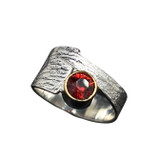 Offset Garnet Ring with 22K gold rim. I cut this Burnt red orange Malaya Garnet in a ‘Classic’ cut design. Very bright stone rimmed with 22K gold setting and set in an offset textured sterling silver ring shank sized 7. Offset Garnet Ring with 22K gold rim. I cut this Burnt red orange Malaya Garnet in a ‘Classic’ cut design. Very bright stone rimmed with 22K gold setting and set in an offset textured sterling silver ring shank sized 7.