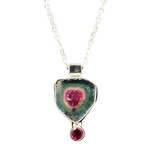 Watermelon Tourmaline Pendant with Garnet Accent. I cut this very large gemmy crystal from a Brazilian specimen acquired in the 1990s! These rare color combos are hard to get now. Set with an African Rhodolite Garnet accent and comes with 18” sterling silver chain. 1” L x ¾” W.