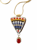 Sterling silver, piece of broken porcelain china, carnelian pendant on a 16-inch snake chain.  The pendant is reversible