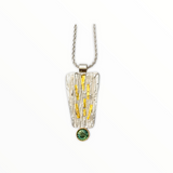 Sterling silver textured pendant with green tourmaline set in gold on a sterling wheat chain