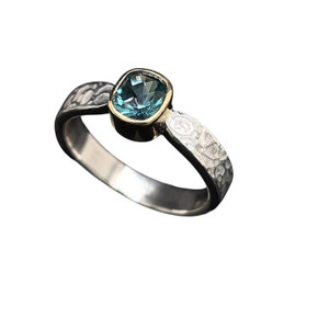 Tourmaline Ring in Gold and Silver. I cut this high quality Afghan tourmaline in a design called ‘Turtle Checker’ with over 70 facet cuts. It’s a unique design with a diamond checkerboard design cut on the table. Beautiful Indicolite tourmaline crystal at 0.8 ct in set in an 18K gold bezel. Ring shank is textured sterling silver in a size 6 ¾  ring.