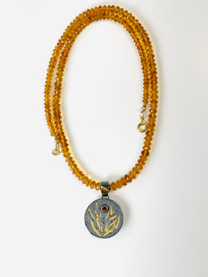 Faceted Madeira citrine beads with a silver /gold pendant