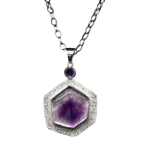 Bi-colored Amethyst Pendant.
I cut this rare amethyst crystal from Morocco where the inner corte is dark and the outer core is clear. By cutting the crystal in cross-section, the pattern becomes evident. Set in fine silver with an amethyst accents stone and comes with an 18” silver chain.