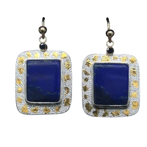 Lapis with Sapphire Earrings with 22K Gold.
Cut these matching rectangular earrings from a rare lapis specimen from the original mines in Afghanistan. These mines are hundreds of years old and the material is deeply colored and is natural and untreated. I cut them in a bookend style because there is a subtle scenic pattern in the stones reminiscent of a midnight sunset scene. Set with blue sapphires in 14K gold filled settings and 22K gold Keumboo highlights. 1”H x ¾ “W.