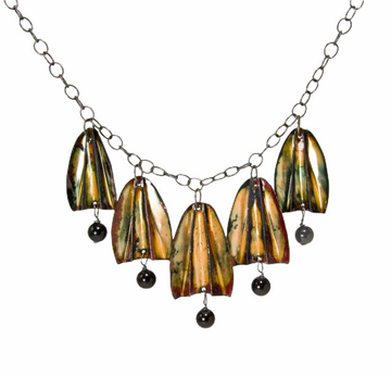 Red and gold enamel tulip flowers with black onyx drops hang from an oxidized sterling silver chain