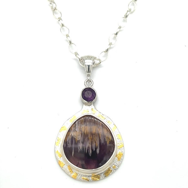 Cacoxenite Amethyst Pendant with Amethyst accent. I cut this unique and hard to acquire amethyst stone which contains needles of golden rutile (titanium crystals) and surrounded it with 22K gold Keumboo accents. 18” sterling silver chain included. One of a kind piece.
