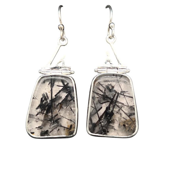 Tourmalinated Quartz Earrings. I cut this matching pair of black tourmaline needles in clear quartz from Brazil.
Matched   with deco accents in sterling silver and hinges that help create movement. Fine silver bezels with sterling silver earwires.