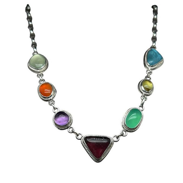 Multi-Gem Stone Necklace. 
A mix of freeform shaped gemstones that I cut with embellished gallery wire in fine silver and sterling silver components. Gemstones include, Rubellite tourmaline, yellow garnet, purple amethyst, reddish rhodolite garnet, Mexican fire opal, green fluorite, Green Marlboro Chrysoprase, and blue apatite. Total length is 18” with lobster clasp.