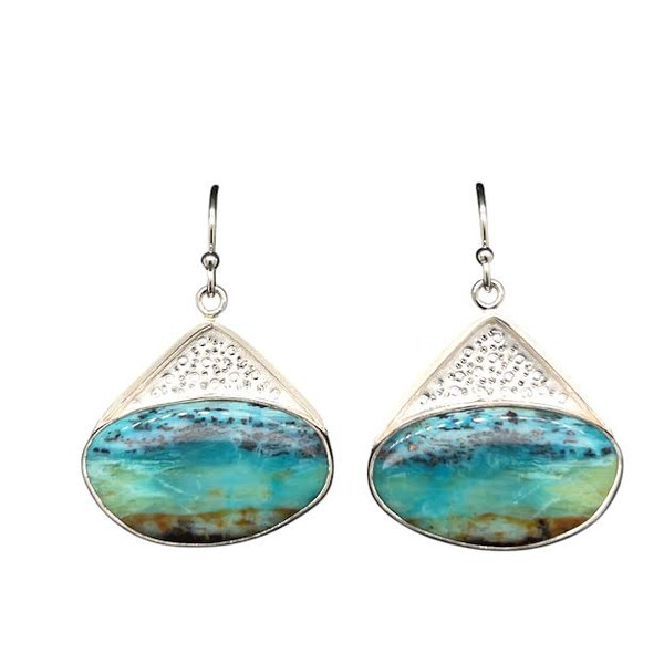 Opalized Petrified Wood Earrings 4. This really cool material comes from Indonesia and I cut these unique shapes with a bookend cut technique so the earrings are mirror images of each other. Hand textured with a new technique using diamond point patterning. Ocean themed scene set in a fine silver bezel and sterling silver ear wire components. .75” L by 1”W.