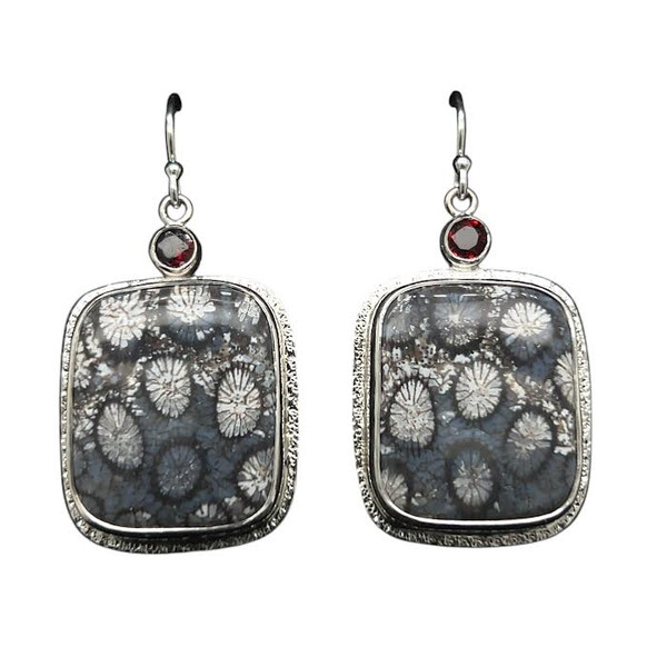 Petrified Coral Earrings with Garnets.
I cut these matching mirror imaged petrified coral stones from a find in Indonesia. The coral polyps are cut in cross-section to showcase the intricate details of their skeletons. Garnet accents are from Africa and set in fine silver bezels with sterling silver components. ¾ “ W by 1” H