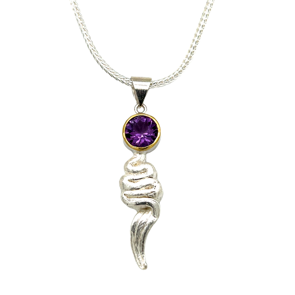 Amethyst pendant in 22K gold and silver. I faceted this Brazilian Amethyst with my favorite ‘Classic” cut design with 58 facets. Set in silver with 22k Gold rim. Special cast project using Mitsuro Hikime waxing technique creates a unique texture. 18” silver braided chain included.