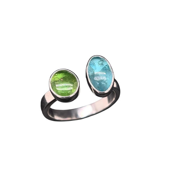 Omega Gemstone Ring. I made this open shank ring with a green Tsavorite Garnet from Tanzania and a blue Apatite from Madagascar. Set in sterling silver in a size 7.5 that is adjustable.