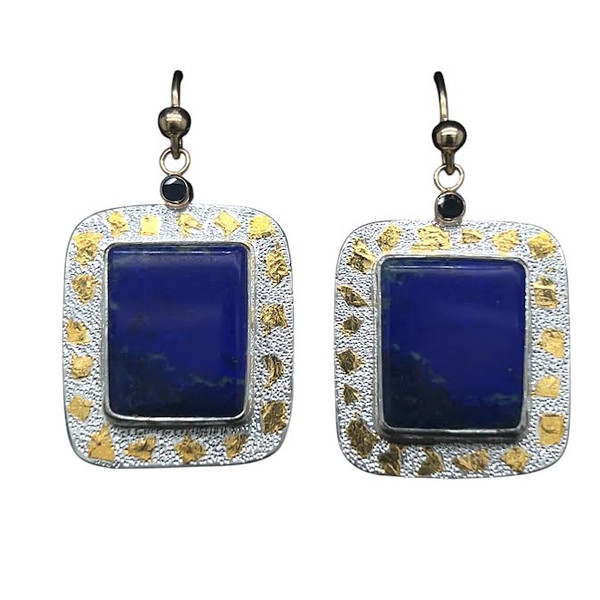 Lapis with Sapphire Earrings with 22K Gold.
Cut these matching rectangular earrings from a rare lapis specimen from the original mines in Afghanistan. These mines are hundreds of years old and the material is deeply colored and is natural and untreated. I cut them in a bookend style because there is a subtle scenic pattern in the stones reminiscent of a midnight sunset scene. Set with blue sapphires in 14K gold filled settings and 22K gold Keumboo highlights. 1”H x ¾ “W.