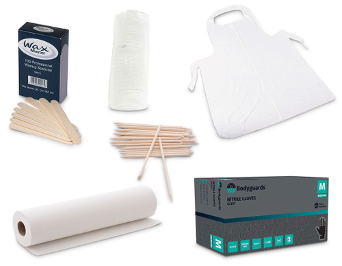Waxing essentials kit with wooden spatulas, couch roll, aprons, gloves and aprons.