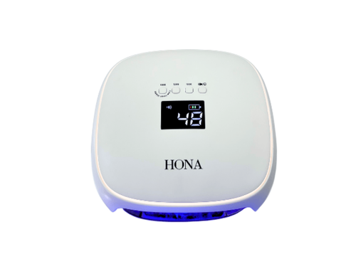 HONA Aura LED nail lamp in white on a white background.