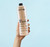 Sienna X 10% spray tan solution 1L held against a blue background
