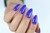 Hand with The GelBottle Inc gel nail polish on the nail in the shade, Bolt.