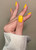 Hand with The GelBottle Inc gel nail polish 2on the nails in the shade, Flashing Lights.